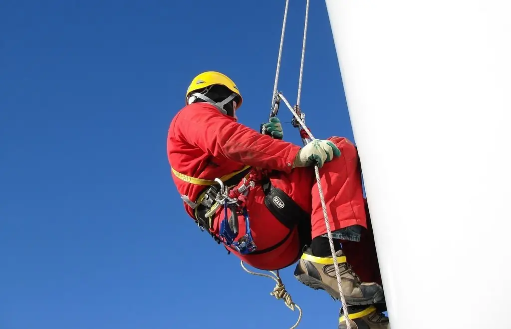 Highmark rope access technician performing sign installation and maintenance work at height in Florida