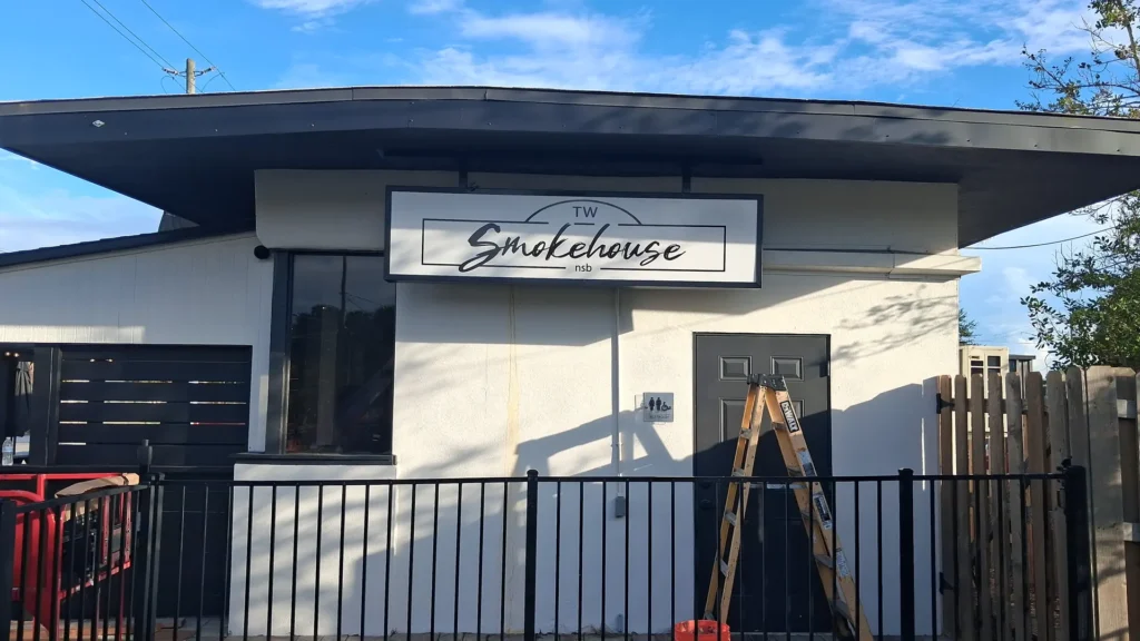 TW Smokehouse illuminated cabinet sign in New Smyrna Beach, FL